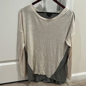 Grey, very light sweater. Longer in the back.